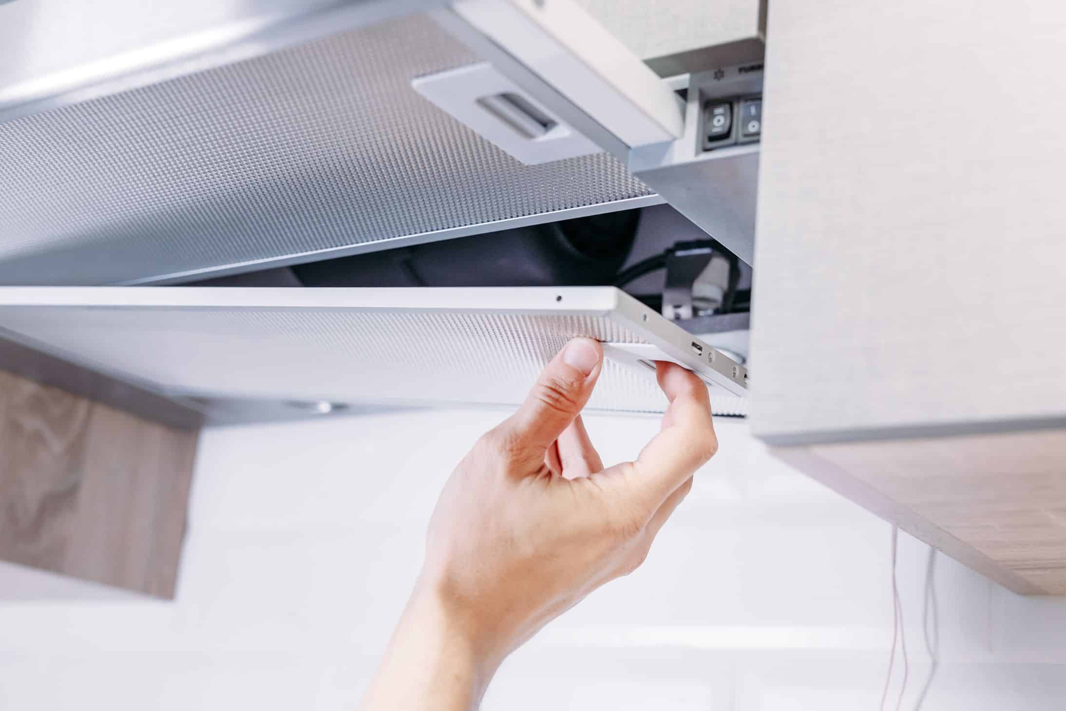 Man fitting parts to a Kitchen Extractor Fan